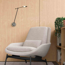 Load image into Gallery viewer, Rotaire LED Adjustable Wall Light in living room.
