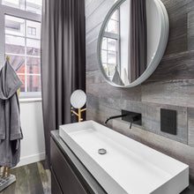 Load image into Gallery viewer, adorne® Pop-Out Outlet in bathroom.
