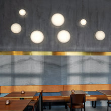 Load image into Gallery viewer, AJ Eklipta Wall Light in living room.
