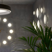Load image into Gallery viewer, AJ Eklipta Wall Light in living room.
