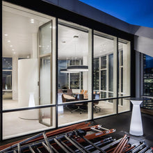 Load image into Gallery viewer, LP Grand LED Pendant Light in living room.
