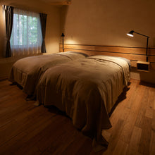 Load image into Gallery viewer, NJP Adjustable LED Wall Light in bedroom.
