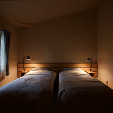Load image into Gallery viewer, NJP Adjustable LED Wall Light in bedroom.
