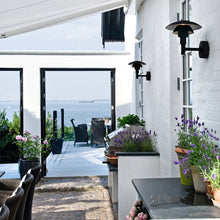 Load image into Gallery viewer, PH 3-2½ Wall Light in Outside Area.

