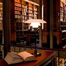Load image into Gallery viewer, PH 4½-3½ Table Lamp in library.
