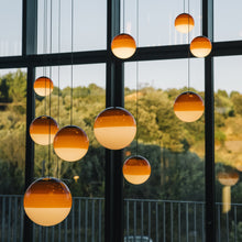 Load image into Gallery viewer, Dipping Light LED Pendant Light in living room.
