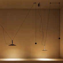 Load image into Gallery viewer, Milana Counterweight LED Pendant Light in living room.
