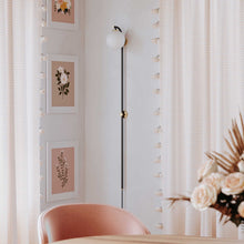 Load image into Gallery viewer, Faye Plug-In LED Wall Light in living room.
