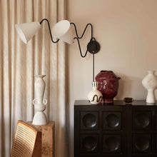 Load image into Gallery viewer, Onda Plug-In Wall Light in dining room.
