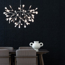 Load image into Gallery viewer, Heracleum III LED Pendant Light in living room.
