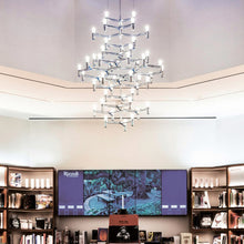 Load image into Gallery viewer, Crown Summa LED Chandelier in living room.
