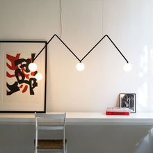 Load image into Gallery viewer, Dabliu Globe LED Pendant Light in living room.
