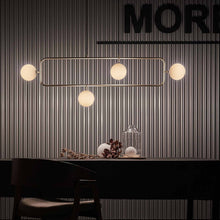 Load image into Gallery viewer, Sircle LED Linear Pendant Light in living room.
