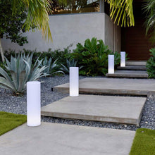 Load image into Gallery viewer, Tower LED Floor Lamp in Outside Area.
