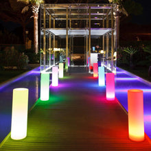 Load image into Gallery viewer, Tower LED Floor Lamp in Outside Area.
