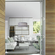 Load image into Gallery viewer, Solis LED Drum Pendant Light in living room.
