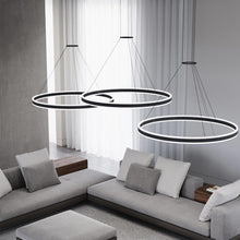 Load image into Gallery viewer, Double Corona™ Ring LED Pendant Light in living room.
