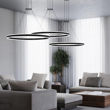 Load image into Gallery viewer, Double Corona™ Ring LED Pendant Light in living room.
