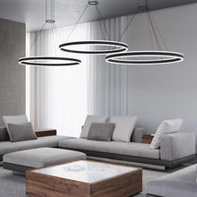 Load image into Gallery viewer, Double Corona™ Ring LED Pendant Light in living room.
