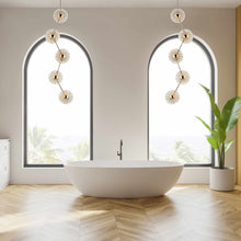 Load image into Gallery viewer, Peony LED Linear Pendant Light in bathroom.
