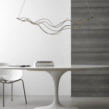 Load image into Gallery viewer, Surge LED Linear Suspension Light in living room.
