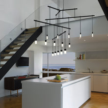 Load image into Gallery viewer, Suspenders® 4-Tier Tri-Bar LED Pendant Light in living room.
