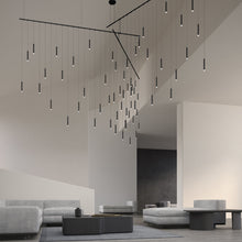 Load image into Gallery viewer, Suspenders® Freeform Tri-Bar LED Pendant Light in living room.
