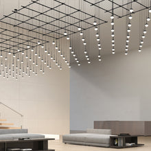 Load image into Gallery viewer, Suspenders® Gridscape LED Pendant Light in living room.
