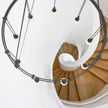 Load image into Gallery viewer, Suspenders® Ring LED Pendant Light in living room.
