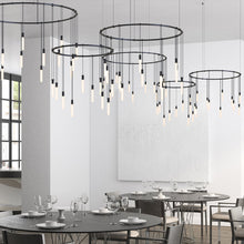 Load image into Gallery viewer, Suspenders® Ring LED Pendant Light in living room.
