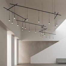 Load image into Gallery viewer, Suspenders® Zig Zag LED Pendant Light with Crystal Cylinder Luminaires in living room.
