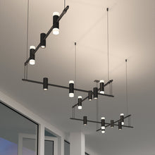 Load image into Gallery viewer, Suspenders® Zig Zag LED Pendant Light with Double Ended Cylinders in living room.
