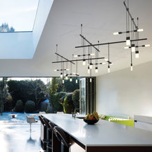 Load image into Gallery viewer, Suspenders® Zig Zag LED Pendant Light with Etched Chiclet Luminaires in living room.
