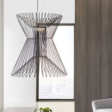 Load image into Gallery viewer, Syrma Grande LED Pendant Light in living room.
