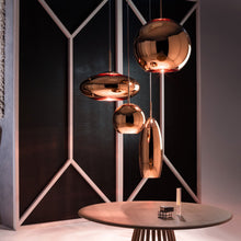 Load image into Gallery viewer, Copper Round LED Pendant Light in exhibition.
