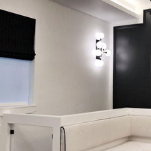 Load image into Gallery viewer, Viaggio Wall Light in bathroom.
