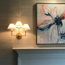 Load image into Gallery viewer, Kelley Triple Wall Light in living room.

